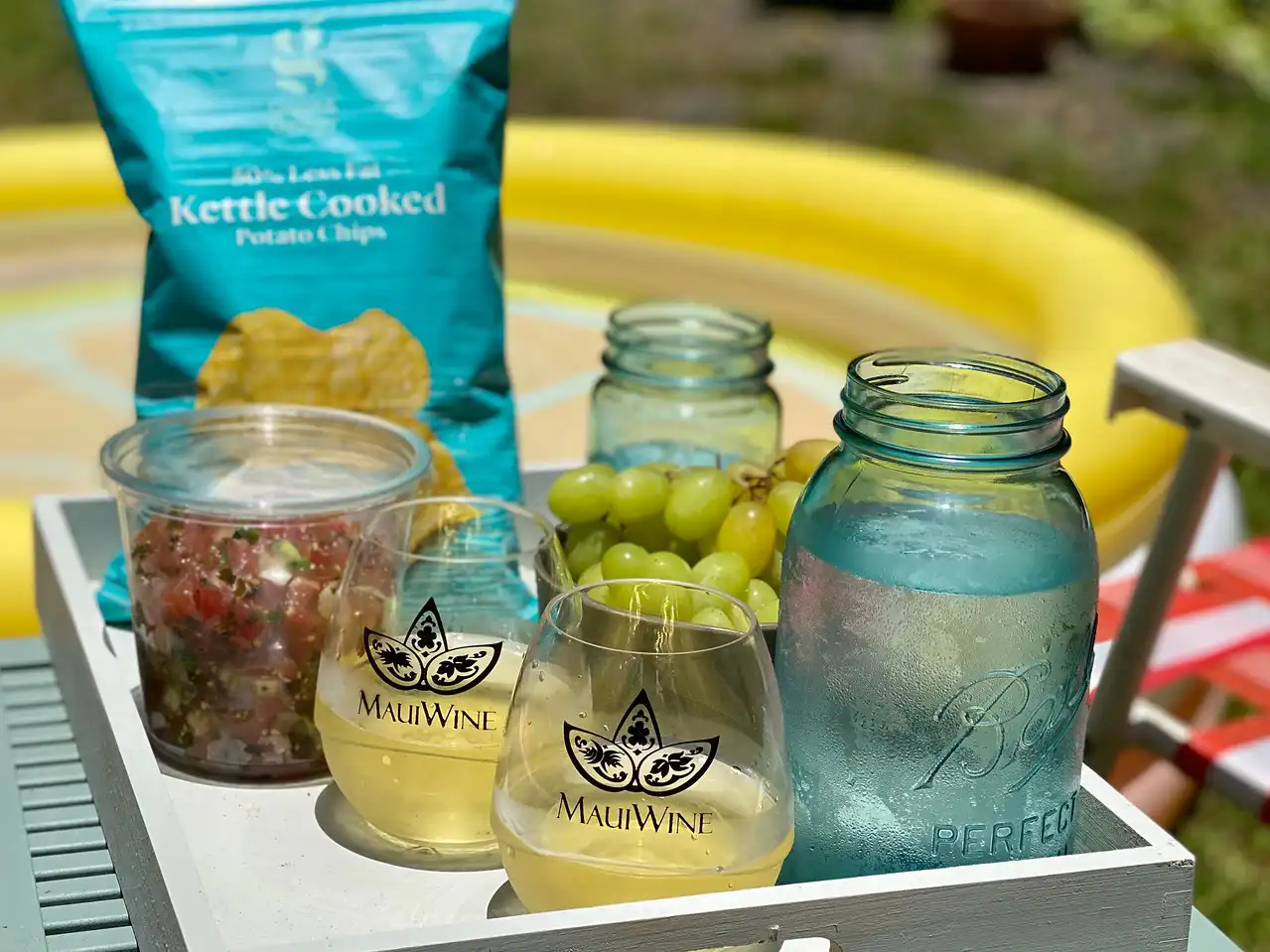 Kula white wine with snacks and mason jars on a tray