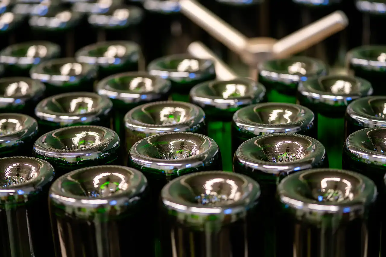 Sparkling wine bottles in a crate during production