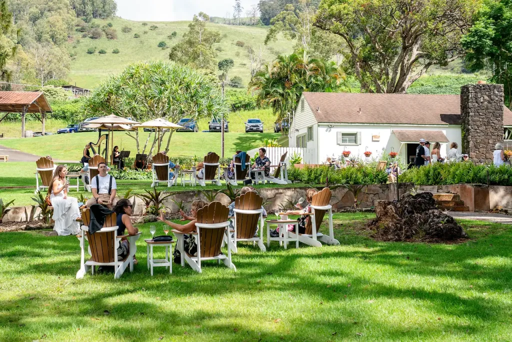 Wine club members gathered on the lawn in front of the King's Cottage