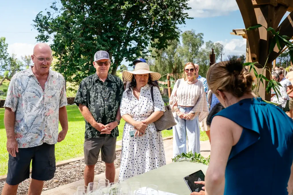 Wine club members talking on the lawn at MauiWine