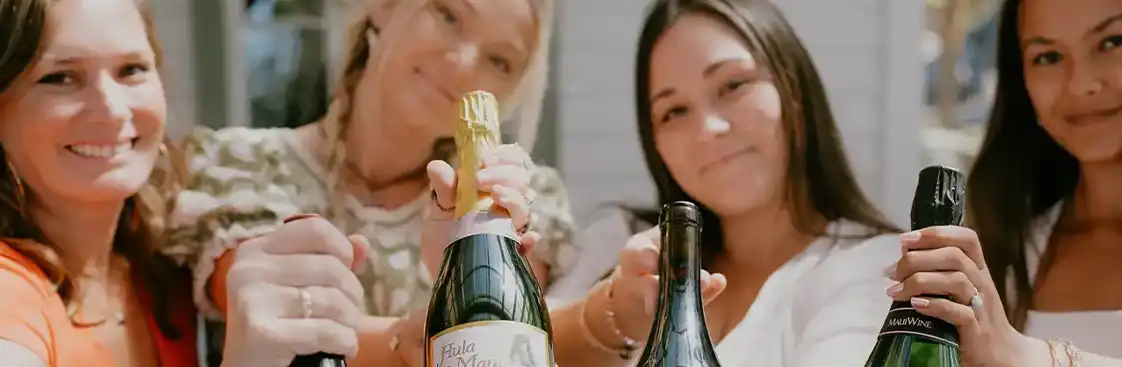 Friends pouring sparkling wine at the Wine Club Summer Social